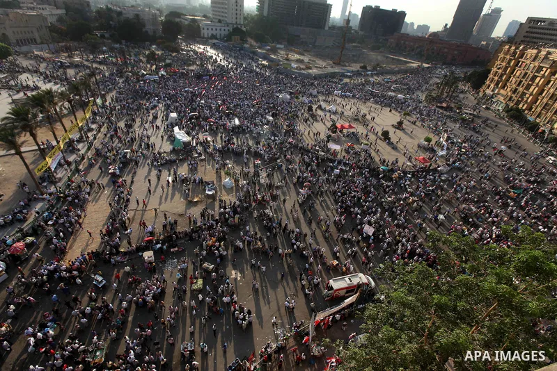 Egyptian protesters wave national flags during a demonstration in Cairo's landmark Tahrir Square on June 5, 2012 to protest against verdicts handed down in ex-president Hosni Mubarak's murder trial. Mubarak and his inter...