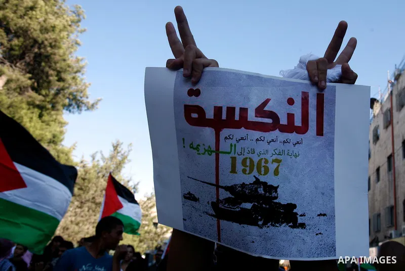 Palestinian protester holds poster during a demonstration marking the 'Naksa Day' at the Damascus Gate on 05 June 2012. Naksa Day is the annual day of commemoration for the Palestinian people of the displacement that acc...