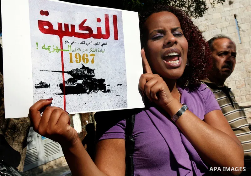 Palestinian protester holds poster during a demonstration marking the 'Naksa Day' at the Damascus Gate on 05 June 2012. Naksa Day is the annual day of commemoration for the Palestinian people of the displacement that acc...