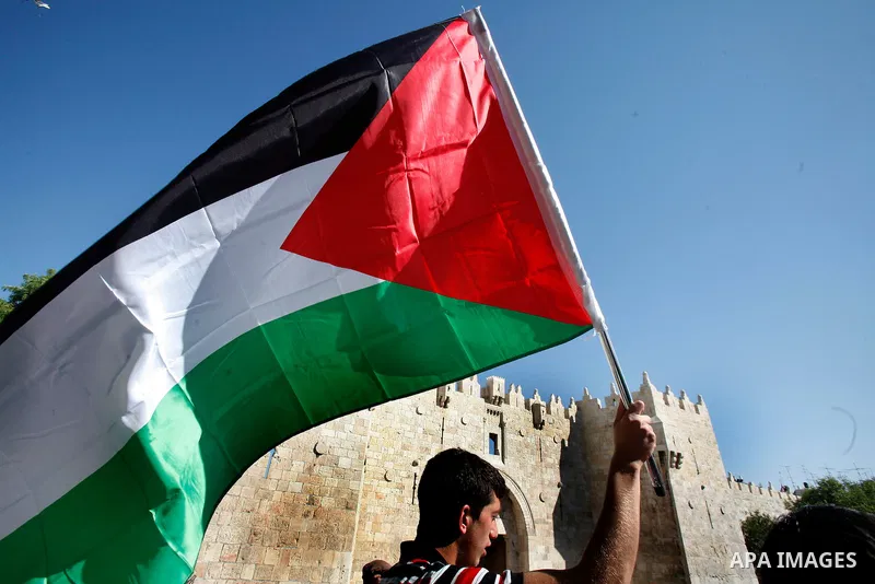 Palestinian protesters hold flags during a demonstration marking the 'Naksa Day' at the Damascus Gate on 05 June 2012. Naksa Day is the annual day of commemoration for the Palestinian people of the displacement that acco...