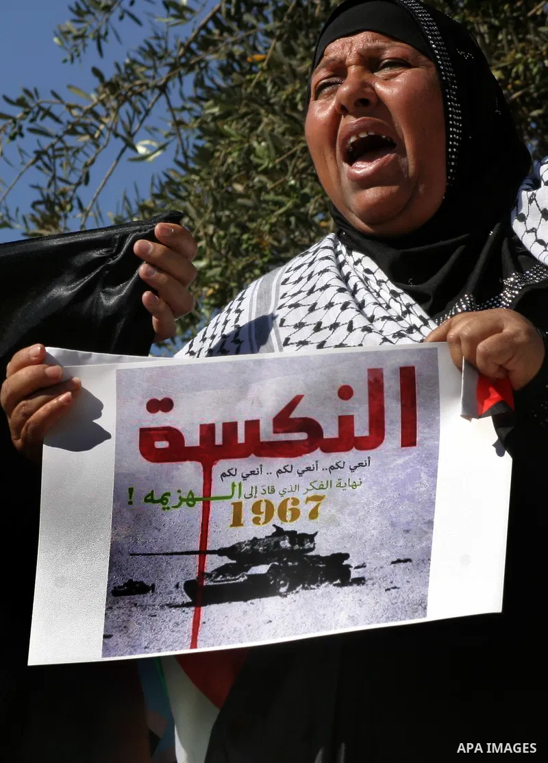 Palestinian protester holds poster during a demonstration marking the 'Naksa Day' at the Damascus Gate on 05 June 2012. Naksa Day is the annual day of commemoration for the Palestinian people of the displacement that acc...