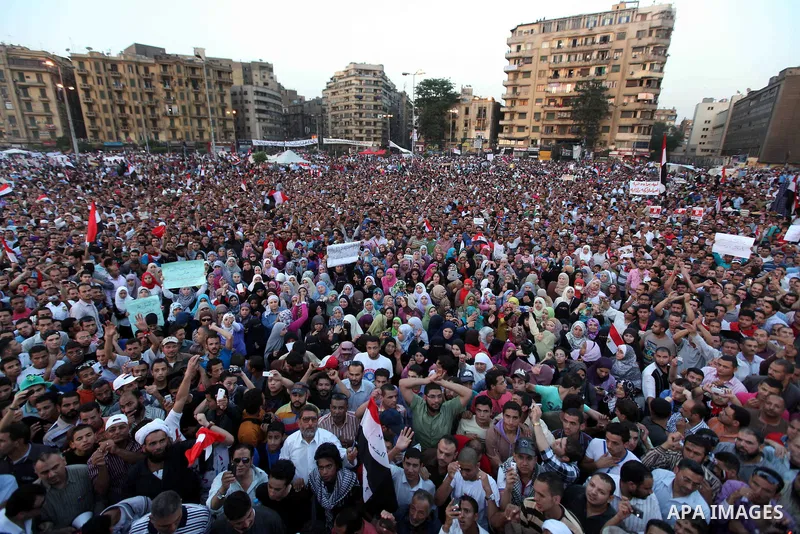 Egyptian protesters wave national flags during a demonstration in Cairo's landmark Tahrir Square on June 5, 2012 to protest against verdicts handed down in ex-president Hosni Mubarak's murder trial. Mubarak and his inter...