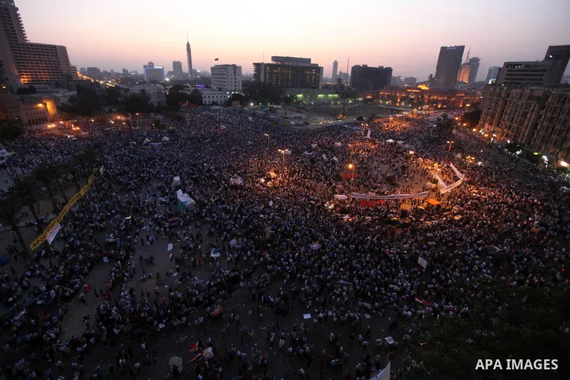 Egyptian protesters wave national flags during a demonstration in Cairo's landmark Tahrir Square on June 5, 2012 to protest against verdicts handed down in ex-president Hosni Mubarak's murder trial. Mubarak and his inter...