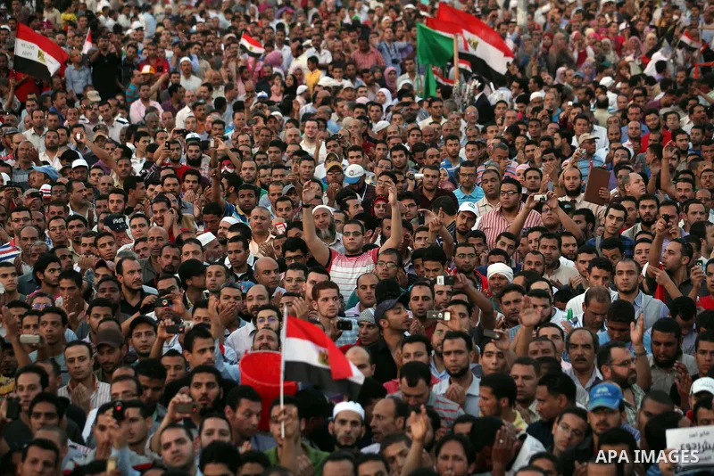 Egyptian protesters wave national flags during a demonstration in Cairo's landmark Tahrir Square on June 5, 2012 to protest against verdicts handed down in ex-president Hosni Mubarak's murder trial. Mubarak and his inter...