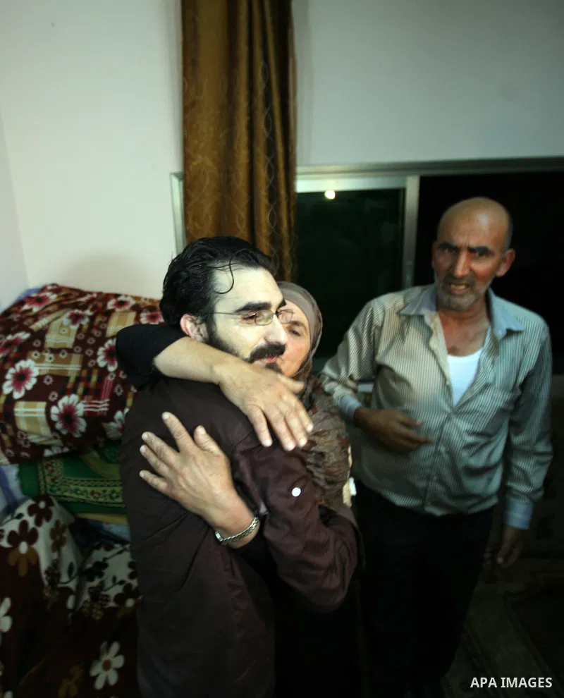 Palestinians celebrate after the Israeli authorities released prisoner Thaer Halahleh in the West Bank Village of Kharas near Hebron on June 05, 2012. Thaer Halahla, 33, from Hebron was in administrative detention for th...