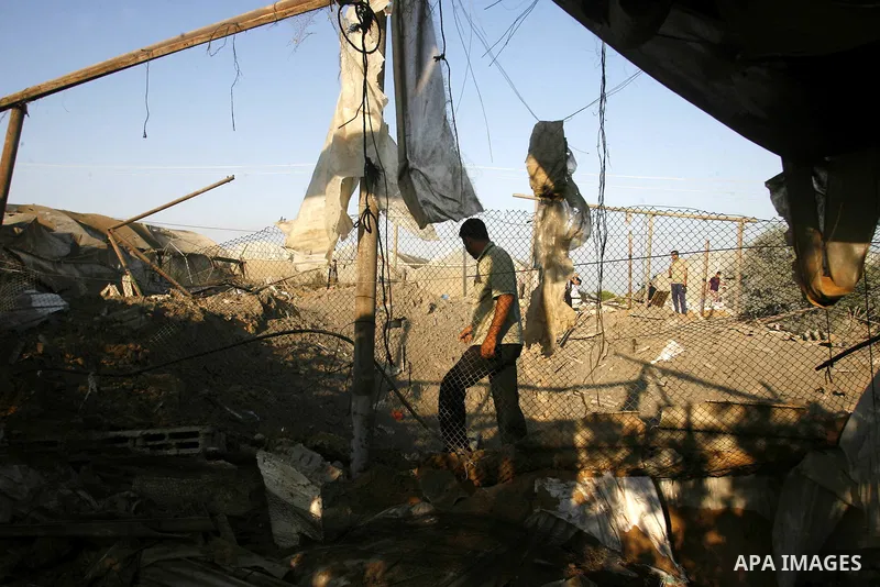 Palestinians inspect the damage at a chicken farm in in the southern Gaza Strip town of Rafah on June 5, 2012 following an Israeli air strike on the Gaza Strip. Photo by Eyad Al Baba