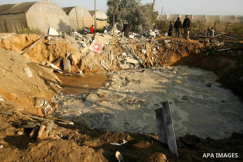 Palestinians inspect the damage at a chicken farm in in the southern Gaza Strip town of Rafah on June 5, 2012 following an Israeli air strike on the Gaza Strip. Photo by Eyad Al Baba