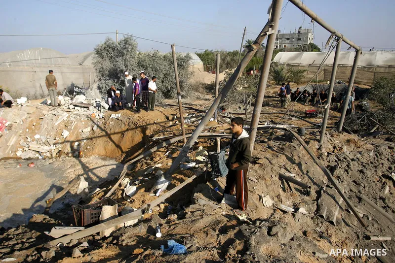 Palestinians inspect the damage at a chicken farm in in the southern Gaza Strip town of Rafah on June 5, 2012 following an Israeli air strike on the Gaza Strip. Photo by Eyad Al Baba