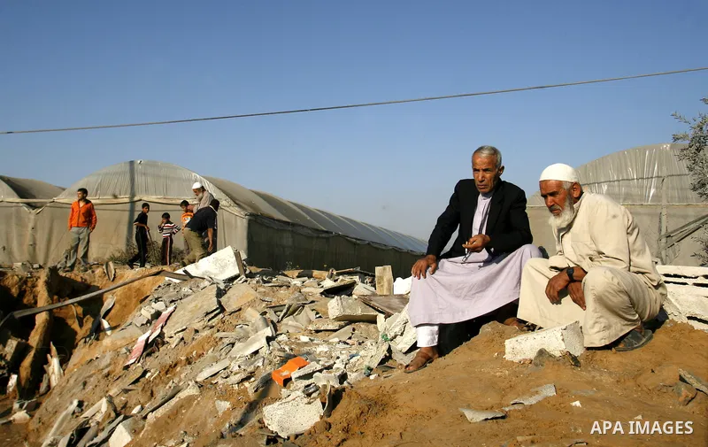 Palestinians inspect the damage at a chicken farm in in the southern Gaza Strip town of Rafah on June 5, 2012 following an Israeli air strike on the Gaza Strip. Photo by Eyad Al Baba