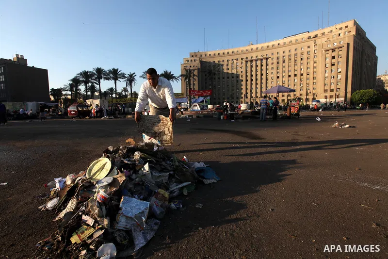 Egyptian protesters clean the street in Cairo's landmark Tahrir Square on June 6, 2012, the day after people demonstrated to protest against verdicts handed down in ex-president Hosni Mubarak's murder trial. Photo by Maj...