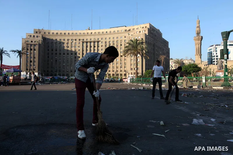 Egyptian protesters clean the street in Cairo's landmark Tahrir Square on June 6, 2012, the day after people demonstrated to protest against verdicts handed down in ex-president Hosni Mubarak's murder trial. Photo by Maj...