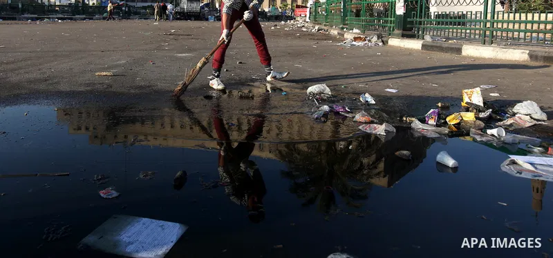 Egyptian protesters clean the street in Cairo's landmark Tahrir Square on June 6, 2012, the day after people demonstrated to protest against verdicts handed down in ex-president Hosni Mubarak's murder trial. Photo by Maj...