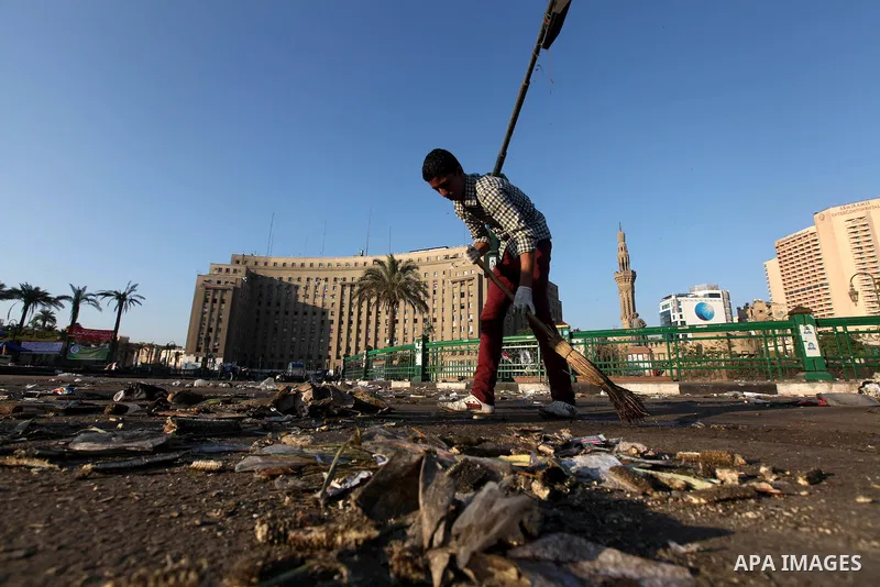 Egyptian protesters clean the street in Cairo's landmark Tahrir Square on June 6, 2012, the day after people demonstrated to protest against verdicts handed down in ex-president Hosni Mubarak's murder trial. Photo by Maj...
