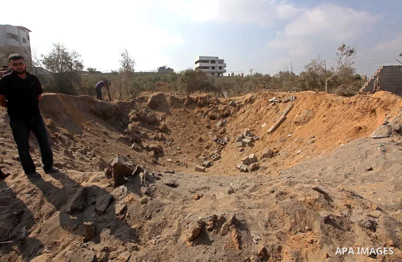 Palestinians inspect the damage at agricultural land in Al Sudania area in the northern Gaza Strip on June 6, 2012 following an Israeli air strike on the Gaza Strip. Photo by Ashraf Amra