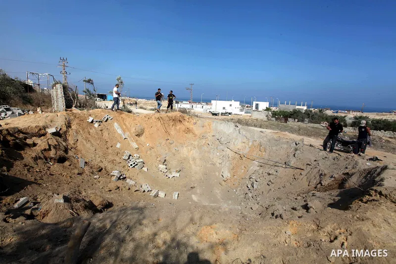 Palestinians inspect the damage at agricultural land in Al Sudania area in the northern Gaza Strip on June 6, 2012 following an Israeli air strike on the Gaza Strip. Photo by Ashraf Amra
