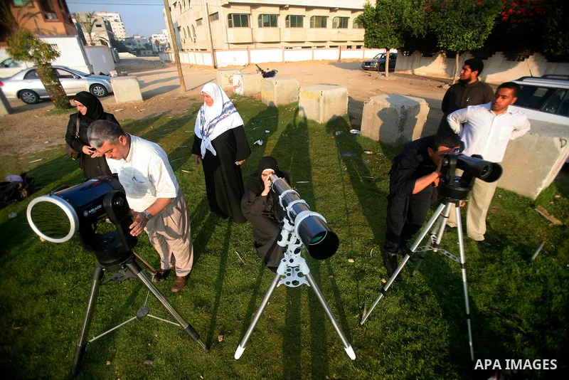 Palestinians look through a telescopes during the transit of planet Venus across the sun face during a rare celestial event in the Gaza Strip, 06 June 2012. Astronomy enthusiasts all over the world looked to the skies to...