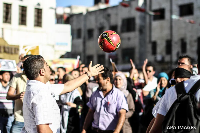 Palestinian youth play football in the streets of Ramallah during a rally solidarity with Palestinian prisoner Mahmoud Al-Sarsak who is still refusing food after a deal was made to end a mass prisoner hunger strike, on 0...
