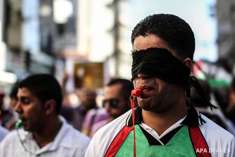 Palestinians shout slogans during a rally solidarity with Palestinian prisoner Mahmoud Al-Sarsak who is still refusing food after a deal was made to end a mass prisoner hunger strike, in the West Bank city of Ramallah on...