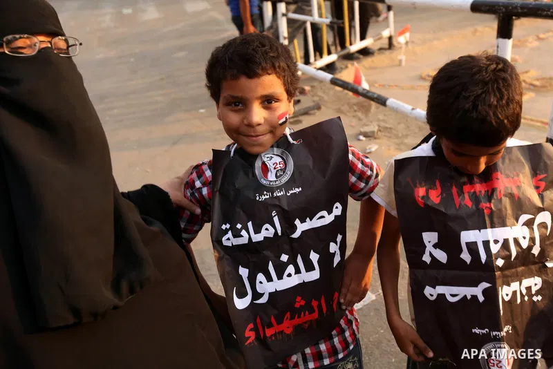 Egyptian children hold banners during demonstration in Cairo's Tahrir square on June 7, 2012. Thousands of Egyptians flocked to Cairo's iconic Tahrir square and other places on Thursday to protest the verdict handed down...