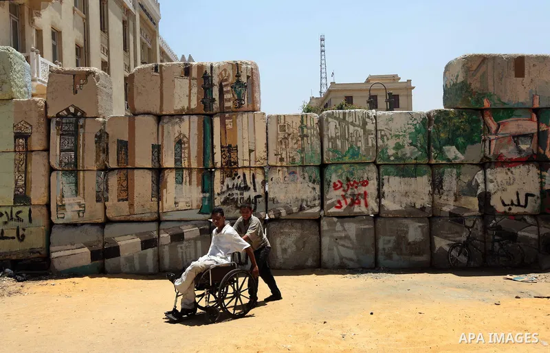 Egyptian protesters stands at Cairo's Tahrir Square during a demonstration against presidential candidate Ahmed Shafiq, as hundreds of people gathered after the Friday noon prayer on June 8, 2012 in the landmark square t...