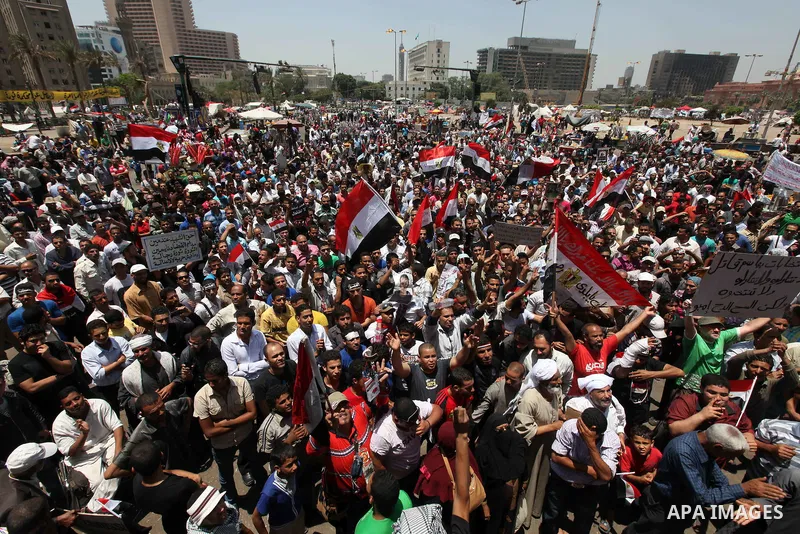 Egyptian protesters wave national flags during a demonstration against presidential candidate Ahmed Shafiq in central Cairo's Tahrir Square, as hundreds of people gathered after the Friday noon prayer on June 8, 2012 in...
