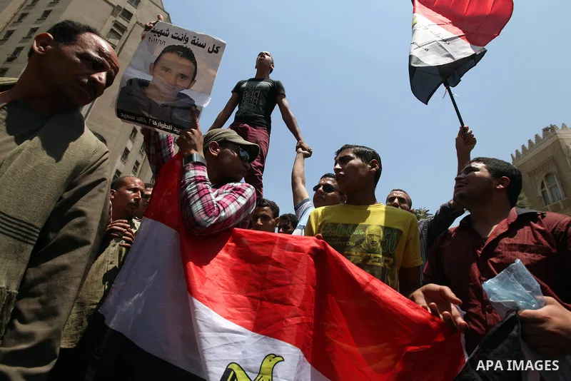 Egyptian protesters wave national flags during a demonstration against presidential candidate Ahmed Shafiq in central Cairo's Tahrir Square, as hundreds of people gathered after the Friday noon prayer on June 8, 2012 in...