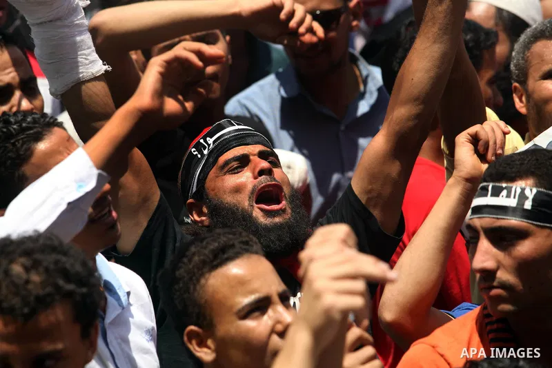 Egyptian protesters wave national flags during a demonstration against presidential candidate Ahmed Shafiq in central Cairo's Tahrir Square, as hundreds of people gathered after the Friday noon prayer on June 8, 2012 in...
