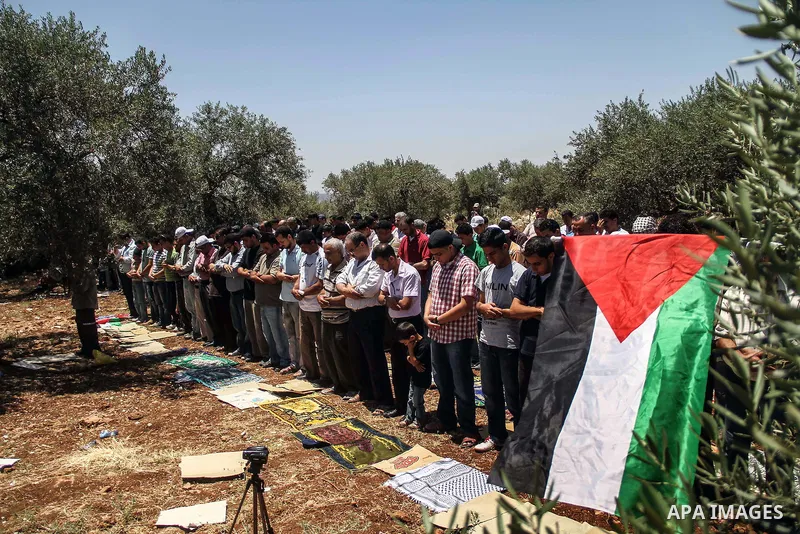 Palestinian worshippers attend Friday prayers before the weekly demonstration against Israel's controversial separation barrier in the West Bank village of Nilin on June 8, 2012. When completed, 85 percent of the wall wi...