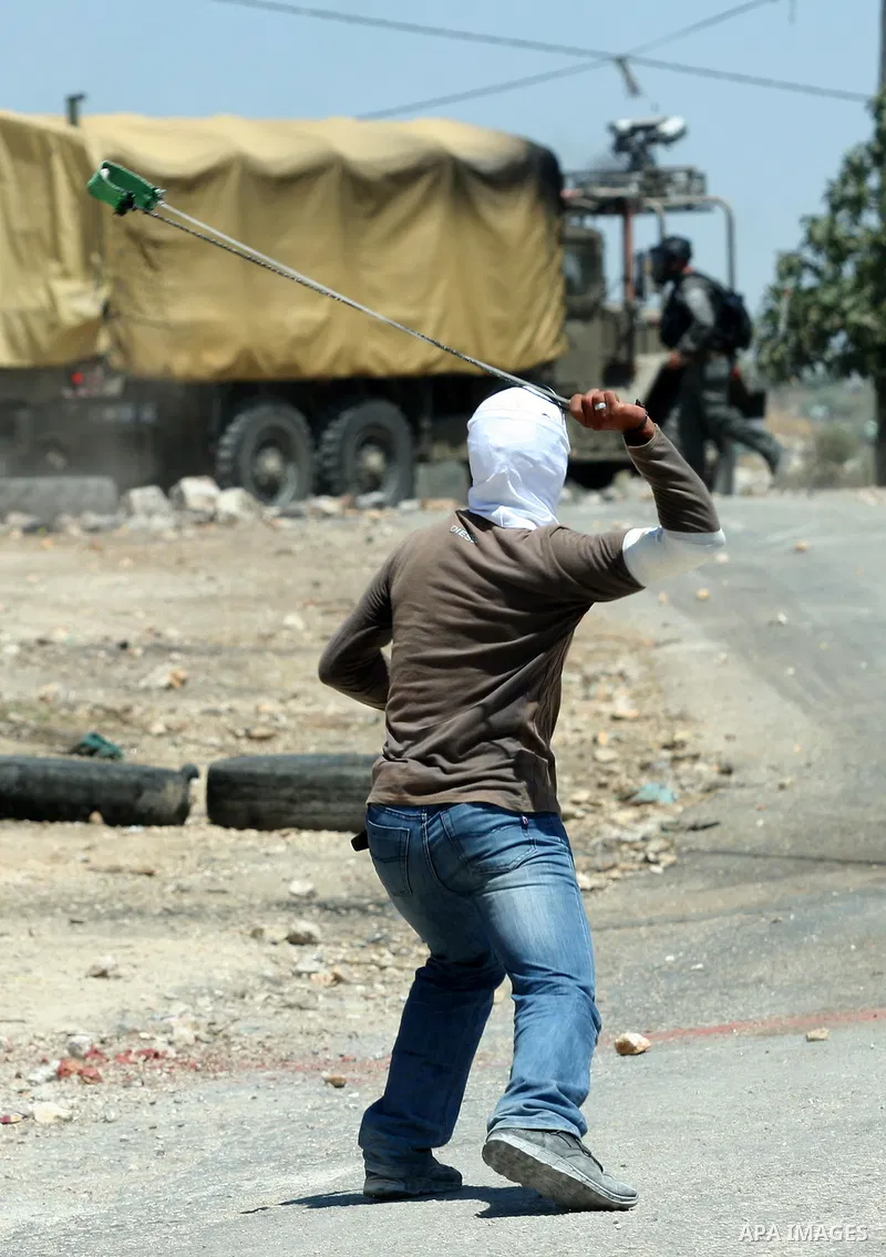 Palestinian protesters throw stones toward Israeli border police during clashes after a demonstration against the nearby Jewish settlement of Kdumim, in the West Bank village of Kfar Kadum, near Nablus June 8, 2012. Phot...