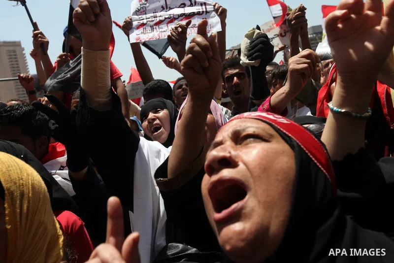 Egyptian protesters wave national flags during a demonstration against presidential candidate Ahmed Shafiq in central Cairo's Tahrir Square, as hundreds of people gathered after the Friday noon prayer on June 8, 2012 in...