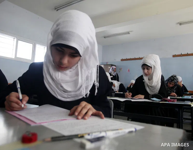 Palestinian Prime Minister in Gaza Strip, Ismail Haniya, (not seen) visits students as they sit for their final high school exams, known as "Tawjihi", in Gaza City on June 09, 2012. Photo by Yasser Fathi
