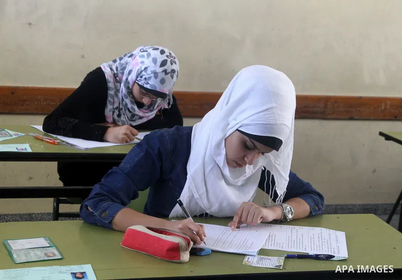 Palestinian Prime Minister in Gaza Strip, Ismail Haniya, (not seen) visits students as they sit for their final high school exams, known as "Tawjihi", in Gaza City on June 09, 2012. Photo by Yasser Fathi