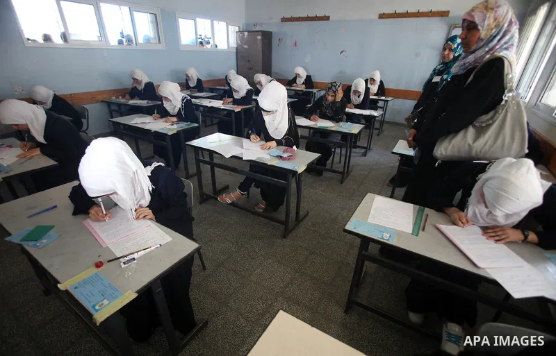 Palestinian Prime Minister in Gaza Strip, Ismail Haniya, (not seen) visits students as they sit for their final high school exams, known as "Tawjihi", in Gaza City on June 09, 2012. Photo by Yasser Fathi