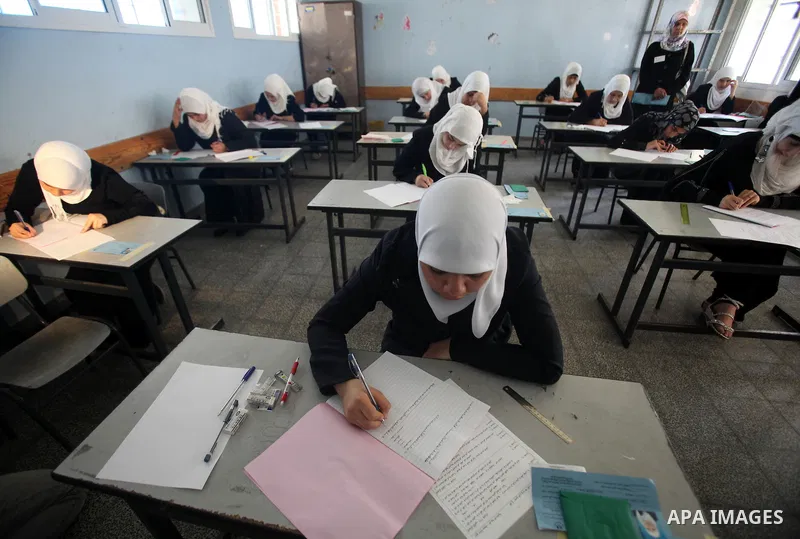 Palestinian Prime Minister in Gaza Strip, Ismail Haniya, (not seen) visits students as they sit for their final high school exams, known as "Tawjihi", in Gaza City on June 09, 2012. Photo by Yasser Fathi