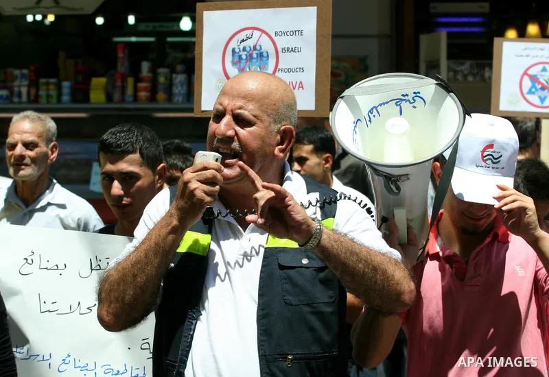 Palestinians demonstrate for a boycott of Israeli goods and support national products during a protest in the West Bank city of Nablus,on June 9,2012. Photo by Nedal Shtieh