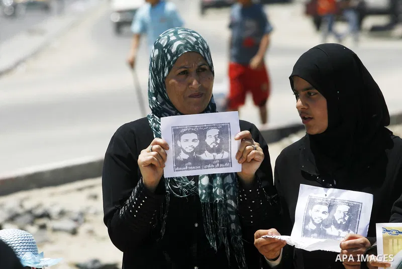 Palestinians hold posters depicting prisoners Mahmoud Al-Sarsak, and Akram al-Rekhawi during a rally in solidarity with them, in Rafah, in the southern Gaza Strip June 9, 2012. Al-Sarsak and al-Rekhawi, two Palestinian p...
