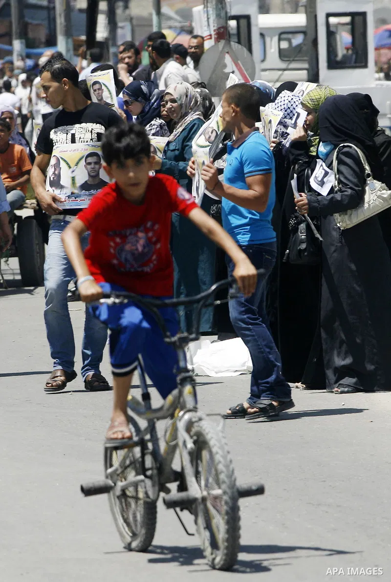Palestinians hold posters depicting prisoners Mahmoud Al-Sarsak, and Akram al-Rekhawi during a rally in solidarity with them, in Rafah, in the southern Gaza Strip June 9, 2012. Al-Sarsak and al-Rekhawi, two Palestinian p...