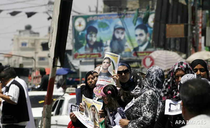 Palestinians hold posters depicting prisoners Mahmoud Al-Sarsak, and Akram al-Rekhawi during a rally in solidarity with them, in Rafah, in the southern Gaza Strip June 9, 2012. Al-Sarsak and al-Rekhawi, two Palestinian p...