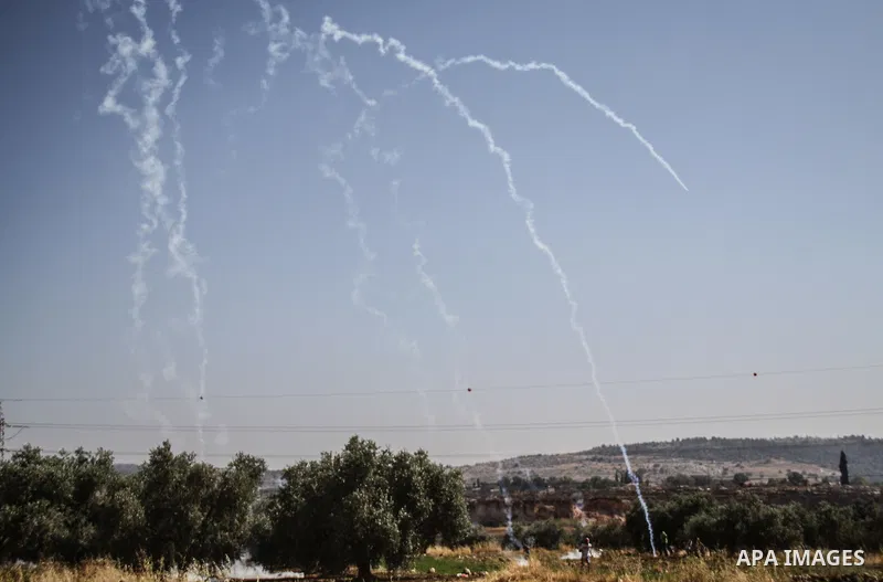 Palestinian demonstrators and Israeli forces clash after a protest by Palestinians calling for the return of displaced Palestinians to their villages occupied by Israel in 1967, in the West Bank village of Beit Nuba, nea...