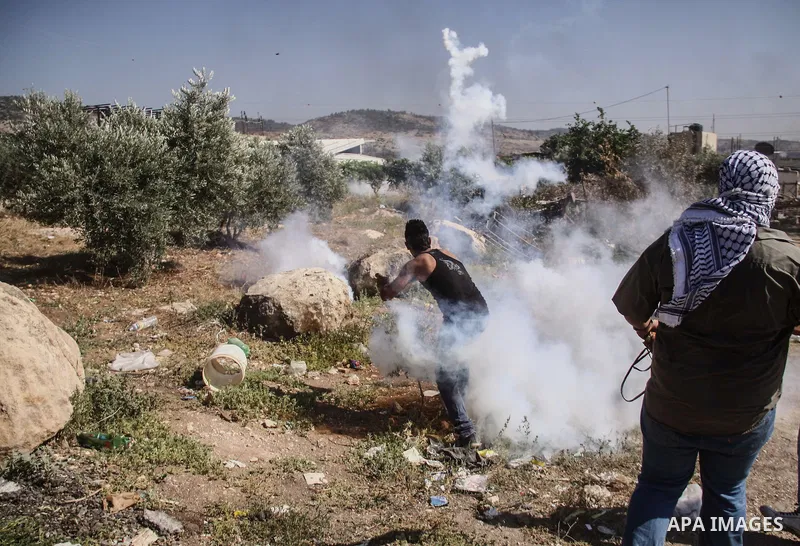 Palestinian demonstrators and Israeli forces clash after a protest by Palestinians calling for the return of displaced Palestinians to their villages occupied by Israel in 1967, in the West Bank village of Beit Nuba, nea...
