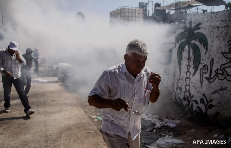 Palestinian demonstrators and Israeli forces clash after a protest by Palestinians calling for the return of displaced Palestinians to their villages occupied by Israel in 1967, in the West Bank village of Beit Nuba, nea...