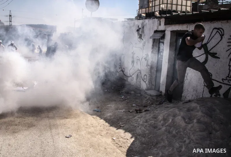 Palestinian demonstrators and Israeli forces clash after a protest by Palestinians calling for the return of displaced Palestinians to their villages occupied by Israel in 1967, in the West Bank village of Beit Nuba, nea...