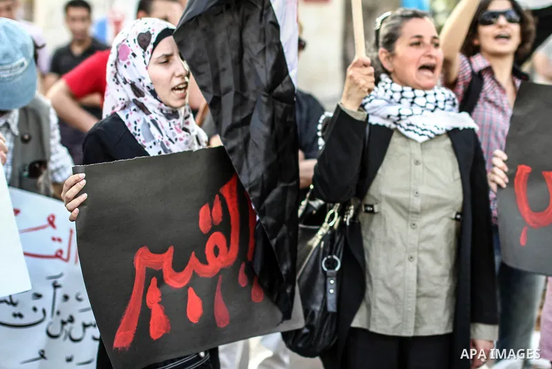 Palestinian protesters shout slogans during a demonstration solidarity with Syrian's revolution and against Bashar Al Asad rule in the West Bank city of Ramallah, on 10 June 2012. Photo by Ahmed Mesleh