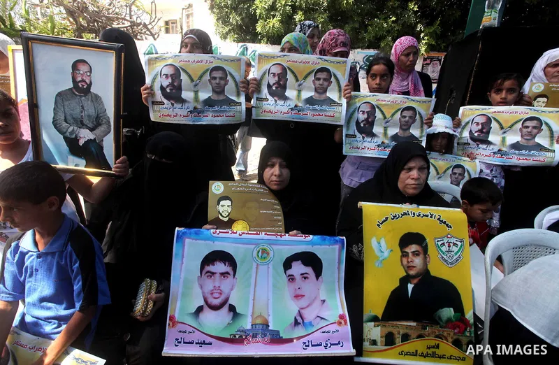 Palestinians gather during a protest at the Red Cross' offices in Gaza City to call for the release of Palestinian prisoners held in Israeli jails, on June 11, 2012. Al-Sarsak and al-Rekhawi are on hunger strike to prote...