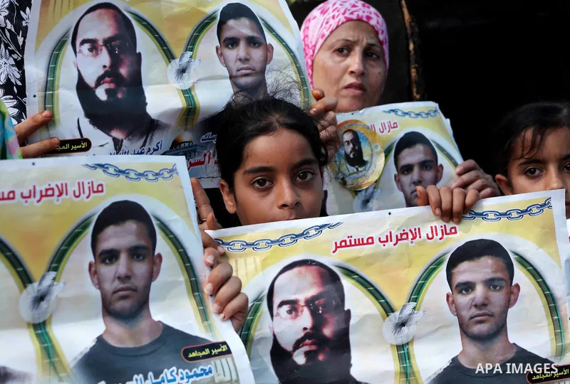Palestinians gather during a protest at the Red Cross' offices in Gaza City to call for the release of Palestinian prisoners held in Israeli jails, on June 11, 2012. Al-Sarsak and al-Rekhawi are on hunger strike to prote...