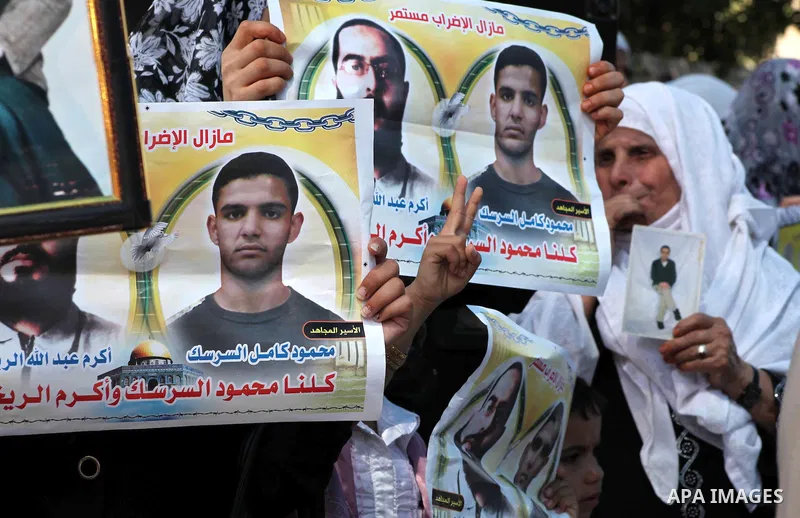 Palestinians gather during a protest at the Red Cross' offices in Gaza City to call for the release of Palestinian prisoners held in Israeli jails, on June 11, 2012. Al-Sarsak and al-Rekhawi are on hunger strike to prote...