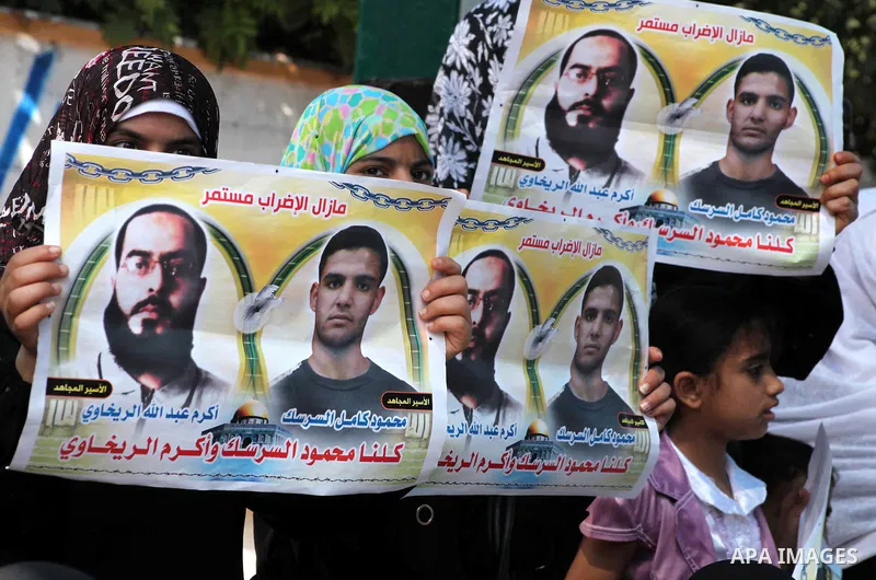 Palestinians gather during a protest at the Red Cross' offices in Gaza City to call for the release of Palestinian prisoners held in Israeli jails, on June 11, 2012. Al-Sarsak and al-Rekhawi are on hunger strike to prote...