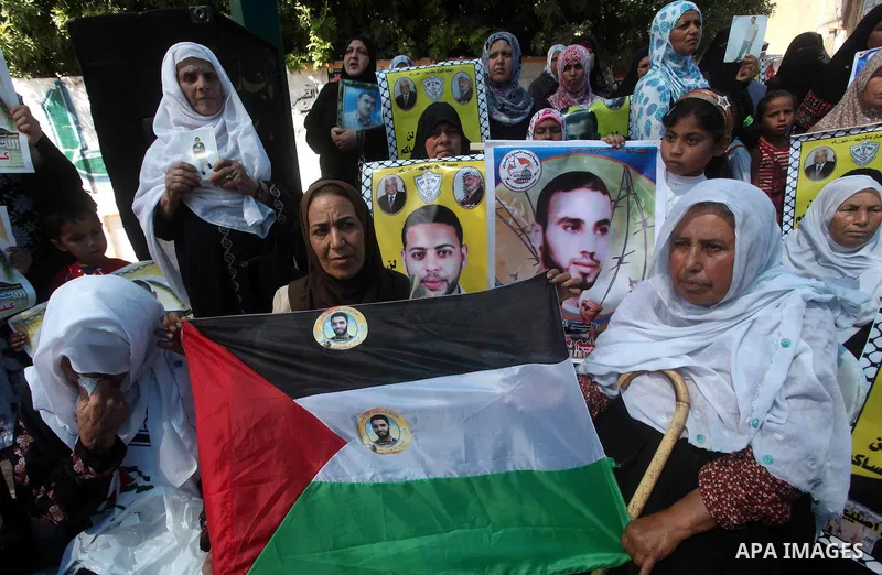 Palestinians gather during a protest at the Red Cross' offices in Gaza City to call for the release of Palestinian prisoners held in Israeli jails, on June 11, 2012. Al-Sarsak and al-Rekhawi are on hunger strike to prote...