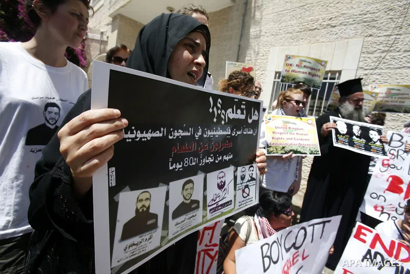 Palestinians and Foreigners hold posters depicting prisoners Mahmoud Al-Sarsak, and Akram al-Rekhawi during a rally in solidarity with them in the red cross offices in jerusalem city, on June 11, 2012. Photo by Mahfouz A...