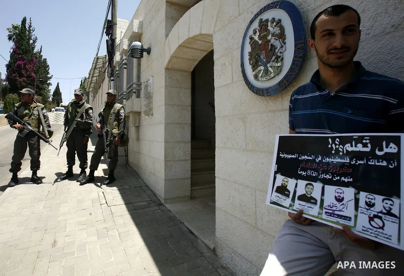 Palestinians and Foreigners hold posters depicting prisoners Mahmoud Al-Sarsak, and Akram al-Rekhawi during a rally in solidarity with them in the red cross offices in jerusalem city, on June 11, 2012. Photo by Mahfouz A...